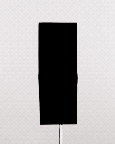 Black 4.0 paint displayed on a vertical surface, showcasing its deep, matte black finish against a light background.