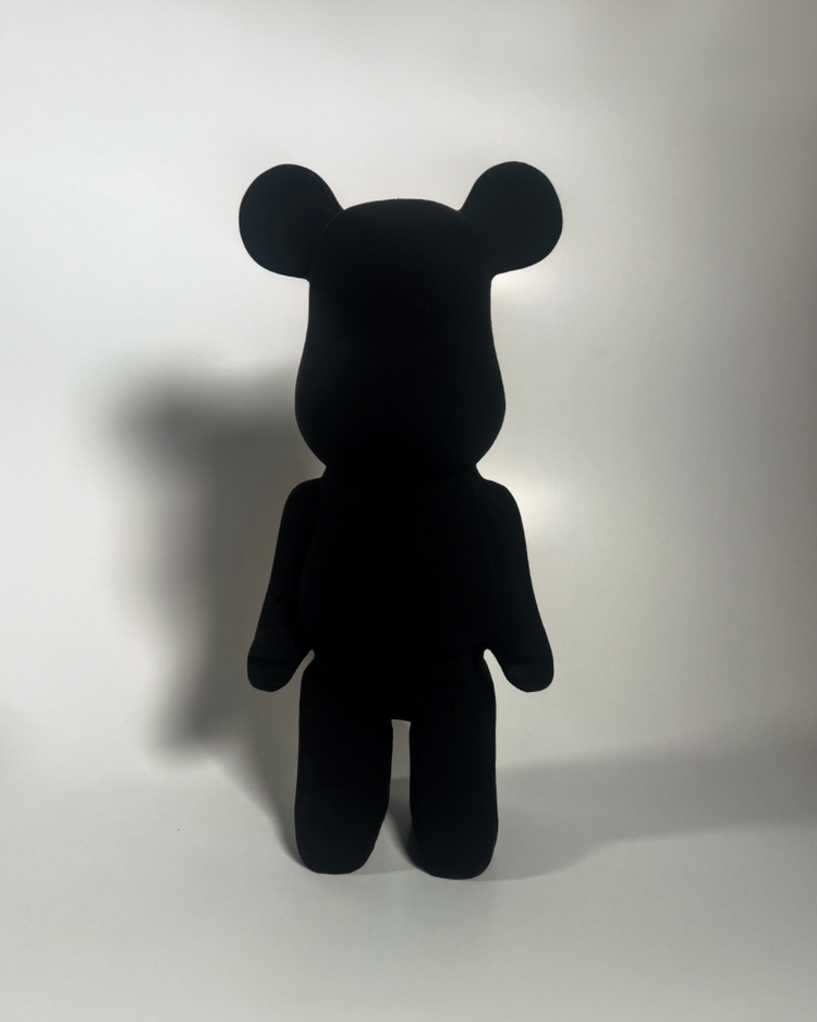 Black 4.0 paint displayed on a matte black bear-shaped figure against a white background.