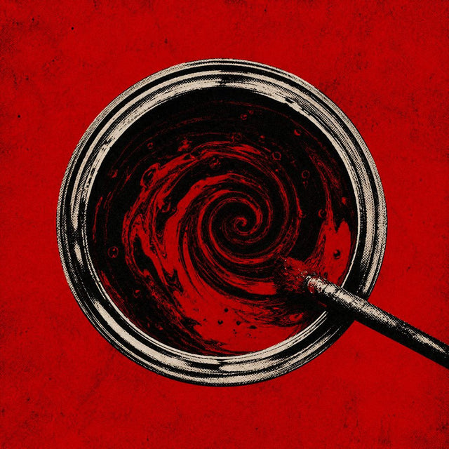 Red paint swirling in a glass dish